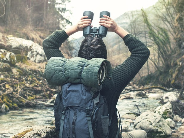 man using binoculars to go birding