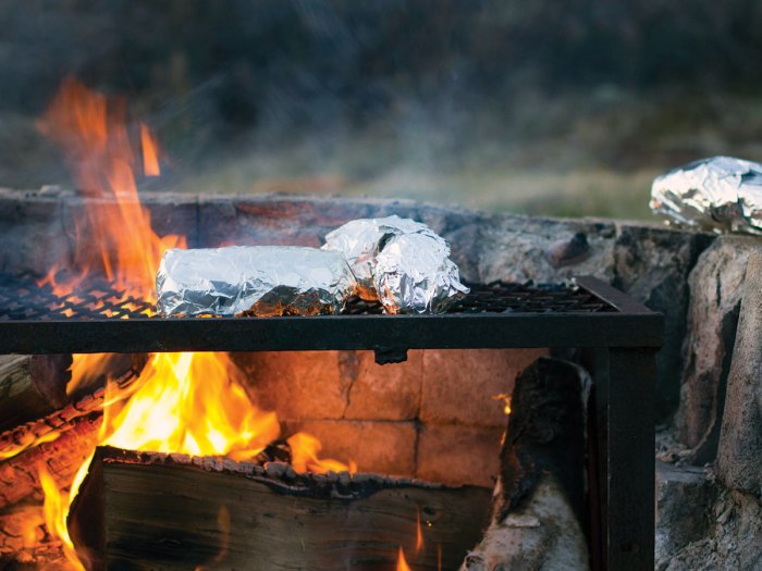 foil meals cooking over a fire