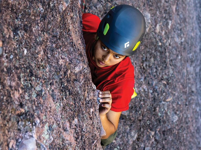 Scout looks for handholds on the rock