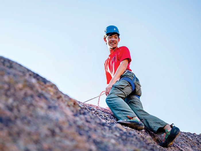 Preparing to descend an outdoor rock climbing wall