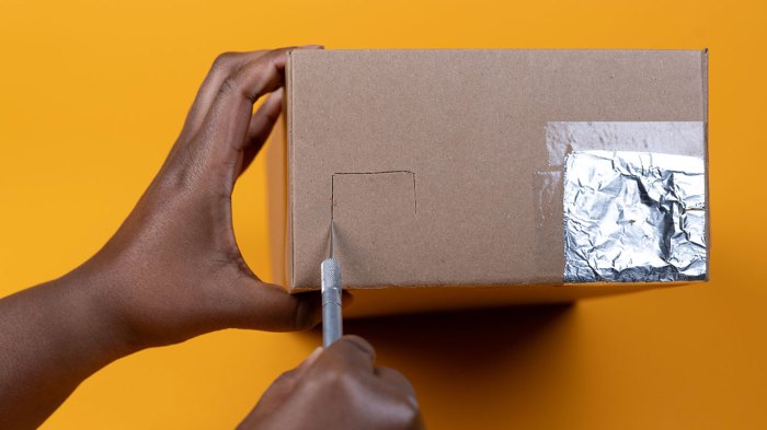 Cutting a second hole in the shoebox to use as a viewing hole