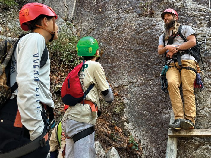 Two Scouts receive instruction from a NROCKS climbing manager